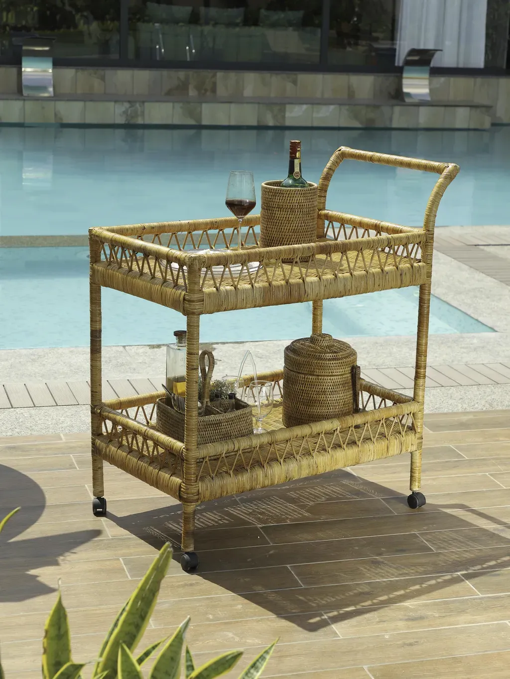 Rattan bar cart beside a pool